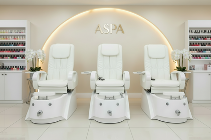 White pedicure chair with armrests and footrest on a white background