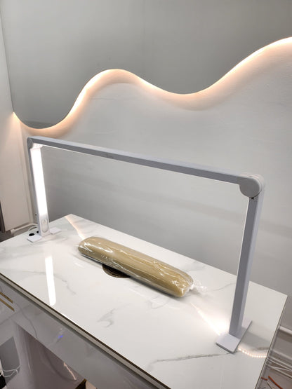 Modern vanity table with a light fixture on a white marble surface.