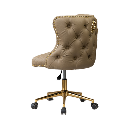 Angled back view of a beige tufted chair with gold nailhead trim and a gold five-star base with caster wheels