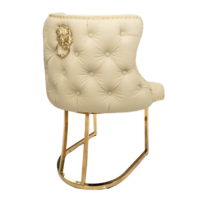 Beige tufted chair with gold accents on a white background