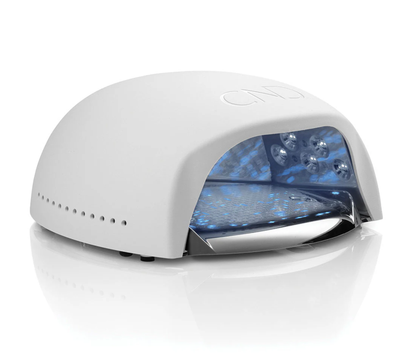 A side view of a white CND branded gel lamp