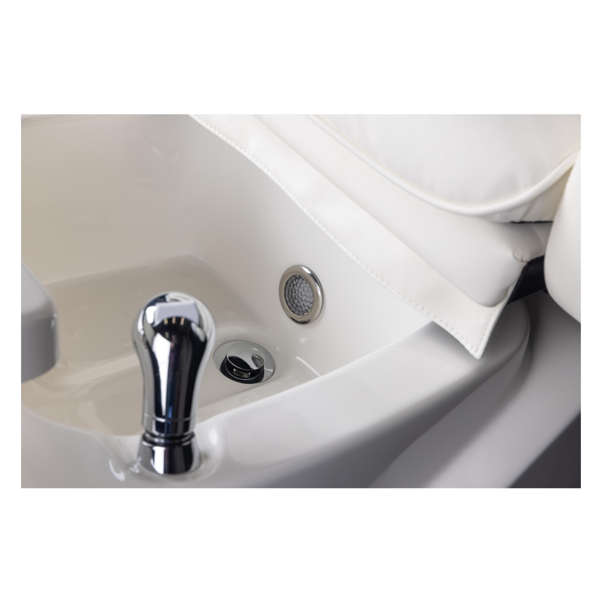 Close-up of a white foot spa with a silver handle and drain cover on a white background