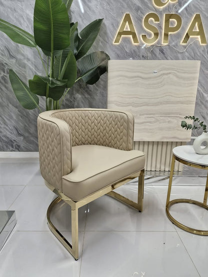Beige armchair with gold legs in a modern interior setting with 'ASPA' branding.