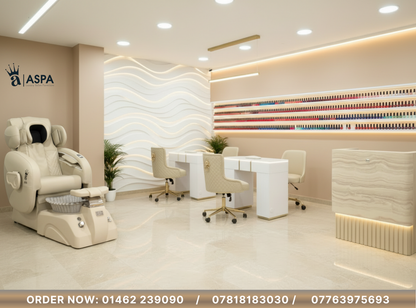 Spa interior with a pedicure chair, reception desk, and decorative elements.