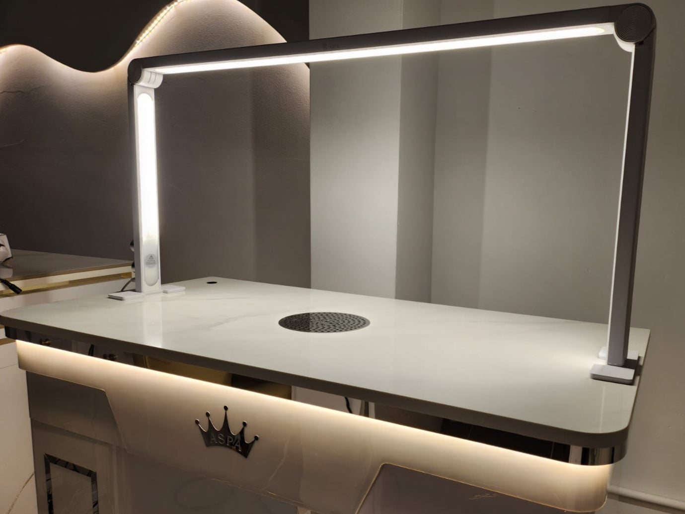 Modern table light with a reflective surface and built-in cooktop.