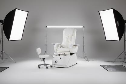 White pedicure chair with foot basin and control panel on a white background