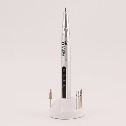 White nail drill tool with attachments on a light gray background