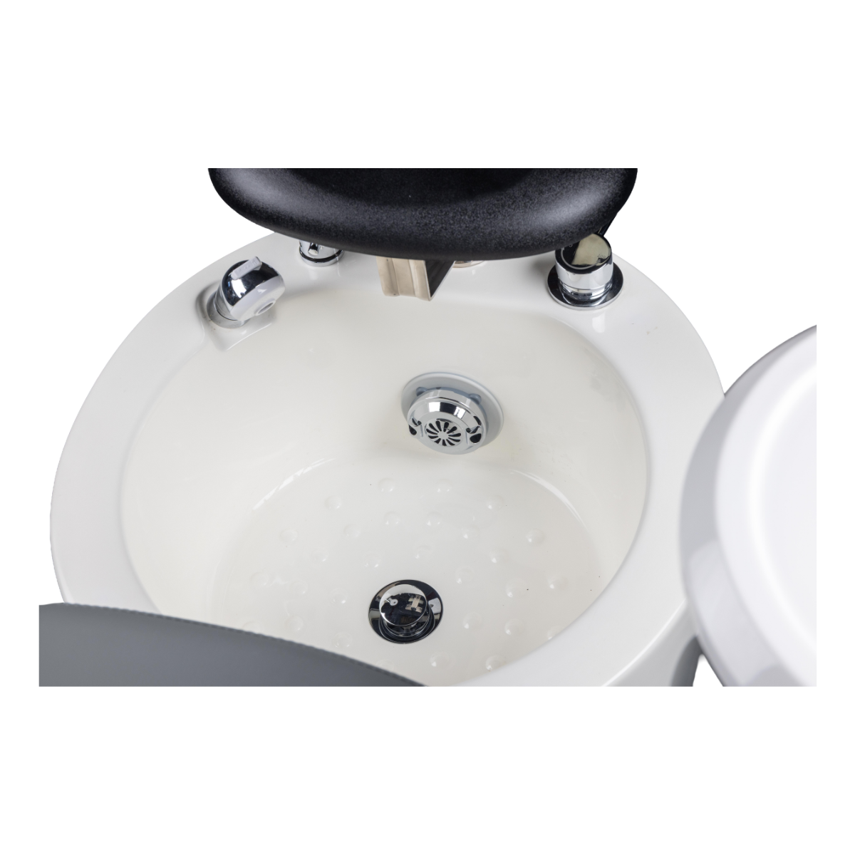 Close-up of a white salon sink of a pedicure chair with black faucet and drain cover on a white background