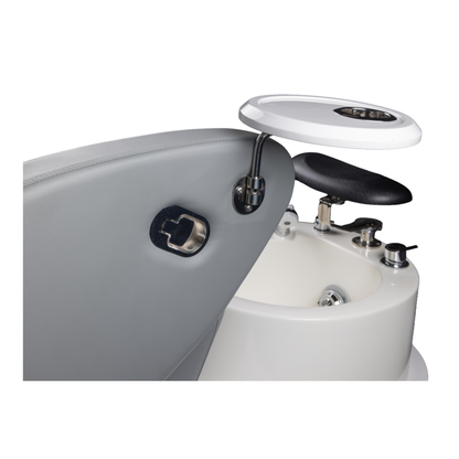 Close-up of a pedal with a white top and black seat on a white background