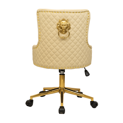 Rear view of a beige upholstered swivel office chair with diamond-quilted backrest, gold lion head ring pull detail, gold nailhead trim around the edges, and a gold five-star base with castors and height adjustment lever.